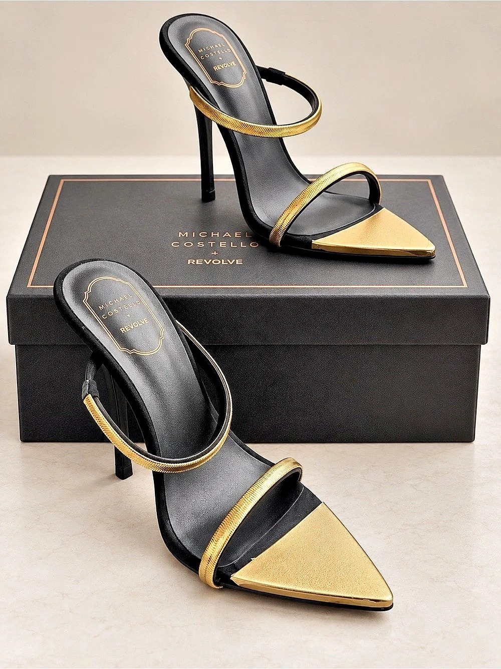 Michael Costello x REVOLVE Gwenn Sandals.
Black & Gold Pointed Toe Heels Like N